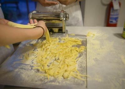 A student making pasta by hand in Italy