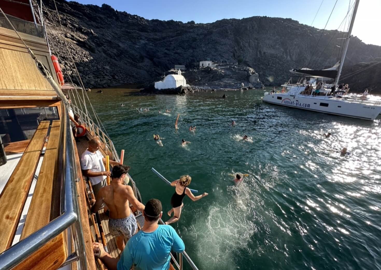 Students jumping into the blue waters in Greece