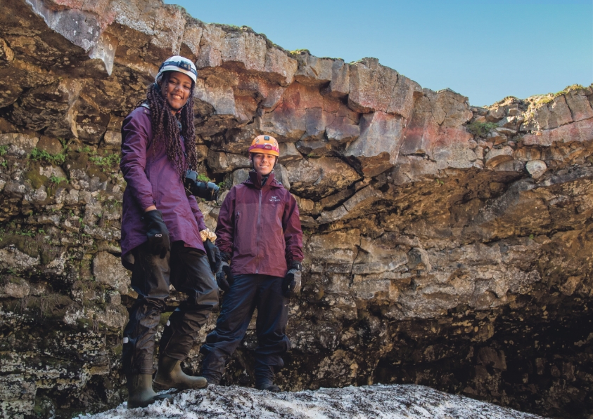 two students standing on glacier in iceland